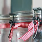 close up of glass jars with ribbon around necks