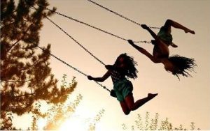 silhouette 2 girls on swings