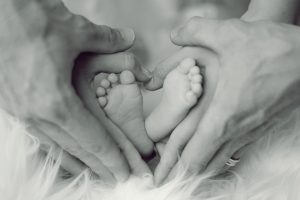 parents hands, baby's feet
